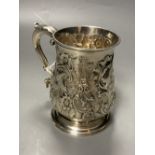 An early George III silver mug, with engraved crest and later embossed decoration, William Shaw