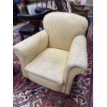 An early 20th century upholstered club armchair