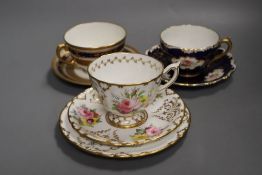 A Royal Crown Derby teacup, a saucer and a tea plate, hand painted with flowers date code 1912, a