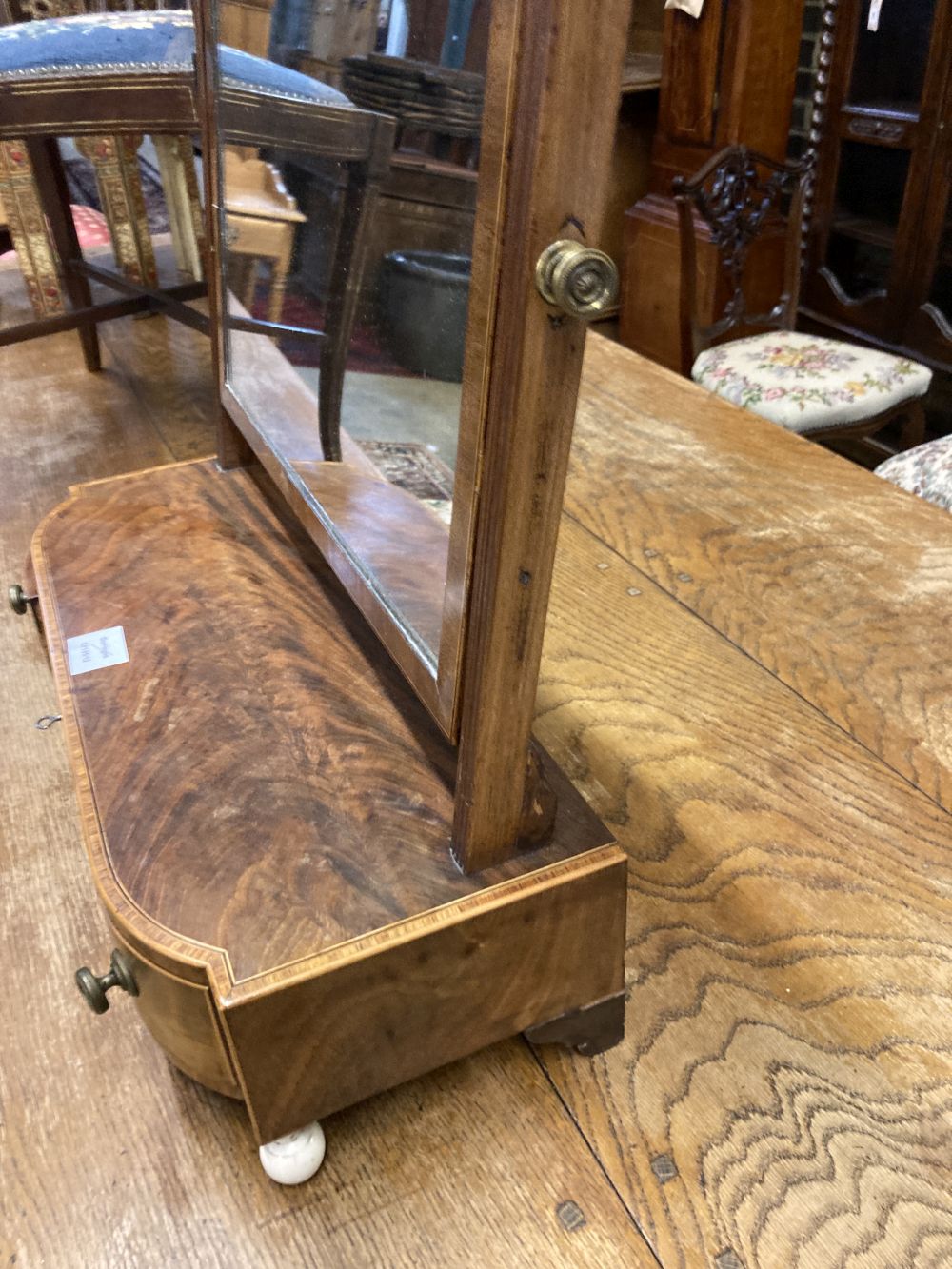 A George III mahogany and tulipwood banded bowfronted toilet mirror, on ivory ball feet, width - Image 3 of 4