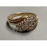 A modern 18ct gold and nineteen stone three stone three row diamond crossover ring, size N, gross