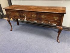 A reproduction mid 18th century oak and mahogany crossbanded dresser, fitted three small drawers,