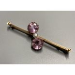 An early 20th century 15ct and three stone pink topaz and seed pearl set crossover bar brooch, 50mm,