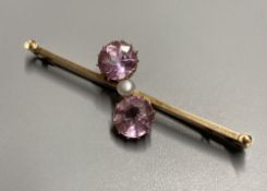 An early 20th century 15ct and three stone pink topaz and seed pearl set crossover bar brooch, 50mm,