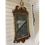 A George II parcel gilt walnut fret cut wall mirror, width 56cm height 120cm