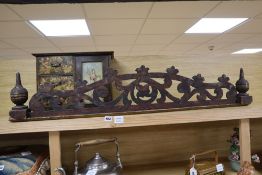 A painted wood hanging wall cupboard and a fret carved and grained wood pediment, 124cm