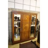 An Edwardian satinwood banded and inlaid mahogany triple wardrobe with fitted interior, width 175cm,