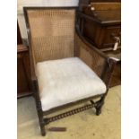 A 1920's oak bergere armchair