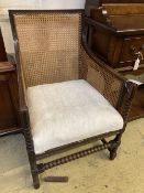 A 1920's oak bergere armchair