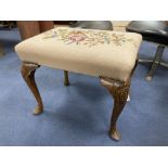 A Queen Anne revival walnut dressing stool, width 57cm depth 43cm height 46cmCONDITION: Woodworm