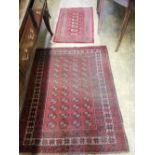 Two Afghan red ground rugs, largest 140 x 110cm