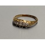 An early 20th century 18ct gold and graduated five stone diamond ring, size O, gross 2.1 grams.