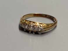 An early 20th century 18ct gold and graduated five stone diamond ring, size O, gross 2.1 grams.