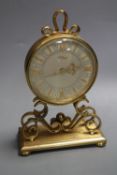 An Imhof vintage gilt brass small mantel clock, having circular Roman dial on scrolled supports