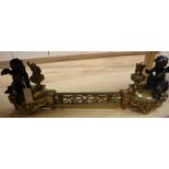 A 19th century French brass fender, classical style with two bronze cherub attendants, width