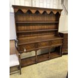 An 18th century style oak dresser, width 182cm depth 45cm height 198cm