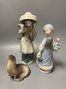 Two Lladro porcelain figures and a Royal Copenhagen model of a seal, tallest 26cm