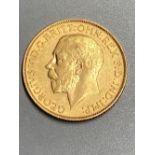 A George V 1913 gold sovereign, GVF.