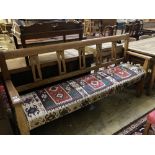 A 19th century Continental oak bench settle, with kelim upholstered seat, width 200cm depth 48cm