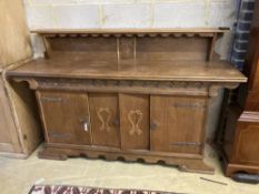 A 1930's oak Gothic inspired sideboard, width 180cm depth 50cm height 116cm