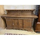 A 1930's oak Gothic inspired sideboard, width 180cm depth 50cm height 116cm