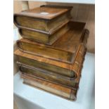 A set of six faux book boxes, four with sliding drawers and two with lids, tallest 51cm width 36cm