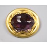 A Victorian pinchbeck and facetted amethyst paste set oval brooch, 37mm.