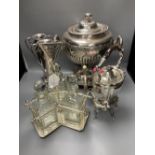 A plated samovar, a kettle on stand, a pair of vases and a three bottle silver plated tantalus and