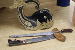 A 19th century Javanese kris, with 14 inch blade, two other edged weapons and a ceremonial head-