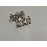 A modern pair of 18ct white gold and solitaire diamond set ear studs, gross 1 gram.CONDITION: One