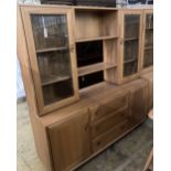 An Ercol elm glazed bookcase, width 155cm depth 44cm height 162cm