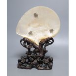 A Chinese mother of pearl shell on wood stand, c.1910CONDITION: Provenance - Alfred Theodore Arber-