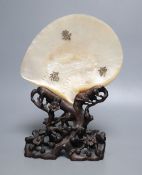 A Chinese mother of pearl shell on wood stand, c.1910CONDITION: Provenance - Alfred Theodore Arber-