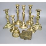 A group of brassware including candlesticks