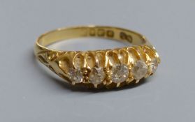 An Edwardian 18ct gold and graduated five stone diamond set half hoop ring, size P/Q, gross 4