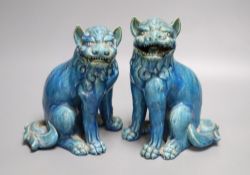 A pair of Japanese turquoise glazed pottery shi-shi, height 23cm