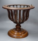 An early 20th century Dutch walnut jardiniere, lacking brass liner