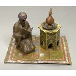 A cold painted bronze desk stand modelled as a reading Arab, length 14.5cm