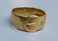 A modern 9ct gold and two white stone chip set buckle ring, size U/V, gross 5.1 grams.CONDITION: