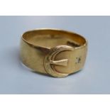 A modern 9ct gold and two white stone chip set buckle ring, size U/V, gross 5.1 grams.CONDITION: