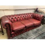 A Victorian style buttoned red leather Chesterfield settee, width 186cm depth 84cm height 66cm