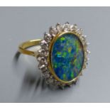 An 18ct, black opal doublet and diamond set oval cluster ring, size M, gross 7.3 grams.CONDITION: