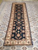 A Ziegler dark blue ground runner with stylised floral motifs, 250 x 80cm