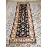 A Ziegler dark blue ground runner with stylised floral motifs, 250 x 80cm