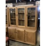 An Ercol display cabinet fitted three glazed panelled doors over cupboards, width 136cm depth 44cm