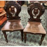 A pair of Victorian mahogany hall chairs