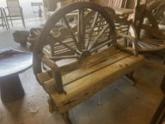 A weathered hardwood cartwheel garden bench, width 140cm depth 70cm height 116cm