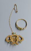 An Edwardian 18ct, turquoise and seed pearl set 'twin hearts with lyre' brooch, 28mm, gross 4.2