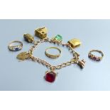 A 9ct gold charm bracelet, hung with six assorted charms including 9ct gold, gross 28.1 grams, an