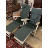 A pair of weathered teak steamer garden chairs with cushions